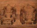 Great carvings cover the front of the wooden temple.